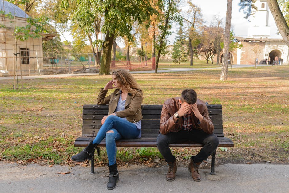 upset couple sitting on bench